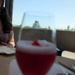 flower in the cocktail with the castle in the glass